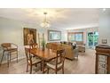 Bright living and dining area features wood-look floors, stylish lighting, and comfortable seating at 1300 N Portofino Dr # 103, Sarasota, FL 34242