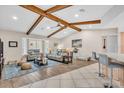 Bright living room boasts vaulted ceilings with wood beams, tile flooring, and ample seating at 1461 Marlin St, Nokomis, FL 34275