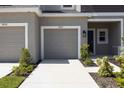 Exterior of a townhome with a one car garage, landscaping and neutral color palette at 16652 Bergamo Pl, Bradenton, FL 34211