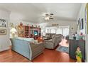 Bright living room with hardwood floors, neutral furniture, and a vaulted ceiling at 20 Idle Sands Dr, Venice, FL 34293
