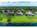 Expansive green backyard view with a lake adding a touch of nature and serenity at 208 147Th Ne St, Bradenton, FL 34212