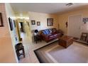 Comfortable living room showcasing tile flooring, complemented by a stylish leather sofa and neutral decor at 2115 Temple St, Sarasota, FL 34239