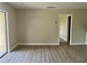 Open-concept living room featuring wood-look flooring and access to a patio at 2636 Hidden Lake N Dr # G, Sarasota, FL 34237
