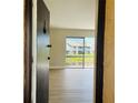 Bright living room with wood flooring, and a sliding glass door leading to an outdoor view at 2636 Hidden Lake N Dr # G, Sarasota, FL 34237
