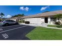 Exterior view showcasing villa, guest parking, partial privacy fence, and meticulously kept landscaping at 2904 64Th W St # 2904, Bradenton, FL 34209
