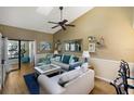 Bright living room with vaulted ceiling, fan, sliding doors, and stylish furnishings at 2904 64Th W St # 2904, Bradenton, FL 34209