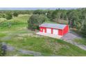 Spacious outbuilding/barn featuring two garage doors, a service door, and a metal roof at 3045 Logue Rd, Myakka City, FL 34251