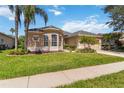 Inviting single Gathering home showcasing a manicured lawn and beautiful landscaping on a bright, sunny day at 315 36Th Ne St, Bradenton, FL 34208