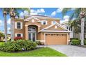 This elegant two-story home features a tile roof, an arched entry, and a two-car garage with beautiful landscaping at 3671 Summerwind Cir, Bradenton, FL 34209