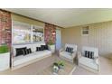 Cozy covered patio featuring stylish outdoor furniture and neutral-toned brickwork for relaxed outdoor living at 444 Flamingo Dr, Apollo Beach, FL 33572