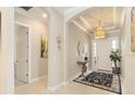 Bright foyer with tile flooring, elegant chandelier, and decorative accents creates a welcoming entrance at 4540 Terrazza Ct, Bradenton, FL 34211