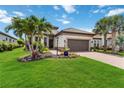 Well-manicured lawn with tropical trees and landscaping creates an inviting curb appeal for this beautiful home at 4540 Terrazza Ct, Bradenton, FL 34211