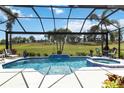Beautiful screened-in pool and hot tub with an expansive backyard view at 4540 Terrazza Ct, Bradenton, FL 34211
