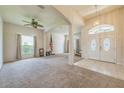 Bright living room featuring neutral carpet, large windows, and an arched entryway at 4915 Bookelia Cir, Bradenton, FL 34203