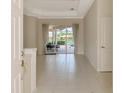 Inviting entryway with tile flooring and a view of the outdoor dining area and pool at 4957 Sabal Lake Cir, Sarasota, FL 34238