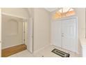 Foyer with double front doors, tile floors, and an arched transom window at 4957 Sabal Lake Cir, Sarasota, FL 34238