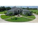 Stunning home featuring a well-manicured lawn, circular driveway, and elegant fountain centerpiece at 520 Rye Ne Rd, Bradenton, FL 34212