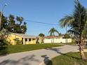 Street view showing the home's position, lawn, and nearby palm trees at 5615 Waneta Pl, Sarasota, FL 34231
