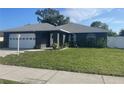 Beautiful single-story home with a lush green lawn, a welcoming front door, and a neatly kept garden at 5848 Milton Ave, Sarasota, FL 34243