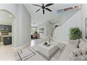 Open concept home features soaring ceilings, neutral paint, modern chandelier, and a staircase to the second story at 6423 Royal Tern Cir, Lakewood Ranch, FL 34202