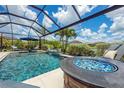 Stunning screened-in pool area with a fire pit and ample seating, perfect for outdoor entertaining at 6507 Clairborne Ln, Bradenton, FL 34211