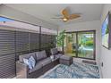 Screened-in patio with comfortable seating, a ceiling fan, and views of the pool at 6563 Silverstar Dr, Sarasota, FL 34240