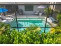 Inviting screened-in pool with sun loungers and umbrella providing a relaxing outdoor space at 6563 Silverstar Dr, Sarasota, FL 34240