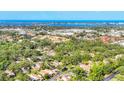 Stunning aerial view of home nestled among lush greenery with a picturesque waterfront backdrop at 6832 Woodwind Dr # 53, Sarasota, FL 34231