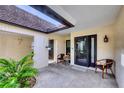 Inviting entryway with outdoor seating, covered porch, and natural light at 6832 Woodwind Dr # 53, Sarasota, FL 34231