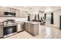 Open-concept kitchen featuring stainless steel appliances and granite countertops at 718 17Th E St, Bradenton, FL 34208