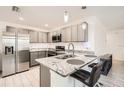 Modern kitchen with stainless steel refrigerator and granite countertops at 718 17Th E St, Bradenton, FL 34208