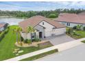 An aerial view of a beautiful single-Gathering home with a tile roof, three-car garage, and lake views at 7228 Great Egret Blvd, Sarasota, FL 34241