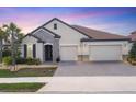 Beautiful single-Gathering home with a brick driveway, a tile roof, stone accents and a two-car garage at 7228 Great Egret Blvd, Sarasota, FL 34241