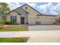 Charming single-Gathering home with stone accents, a tile roof, landscaped yard, and a spacious 3-car garage at 7228 Great Egret Blvd, Sarasota, FL 34241