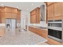 Modern kitchen featuring stainless steel appliances, granite countertops, and wood cabinets at 7228 Great Egret Blvd, Sarasota, FL 34241