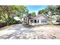 Charming single-Gathering home with ample parking and a quaint front porch nestled beneath lush, mature trees at 809 30Th E Ave, Bradenton, FL 34208