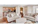 Inviting living room with two couches, a view of the kitchen, and hardwood floors at 8168 Villa Grande Ct, Sarasota, FL 34243