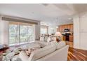 Bright living room featuring a floral rug, neutral furniture, and a screened patio at 8168 Villa Grande Ct, Sarasota, FL 34243
