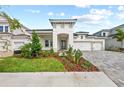 Charming home with a well-manicured lawn, lush landscaping, and an inviting covered entryway at 10309 Longmeadow Ave, Parrish, FL 34219