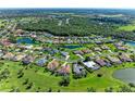 Overhead shot of a residential area featuring ponds, mature trees, and meticulously maintained lawns at 11915 Oak Ridge Dr, Parrish, FL 34219