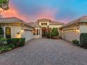 Attractive home with courtyard garage doors, brick drive and well-maintained landscaping at 12448 Highfield Cir, Lakewood Ranch, FL 34202
