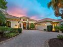Beautiful property with tropical landscaping, brick drive and a tile roof at 12448 Highfield Cir, Lakewood Ranch, FL 34202