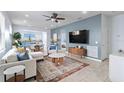 Open-concept living area with blue accent wall, and seamless flow into the kitchen and dining at 13805 Posada St, Venice, FL 34293