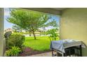 Back patio overlooking the pond with an outdoor dining set and green space at 1426 Harbour Blue St, Ruskin, FL 33570