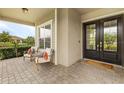 Welcoming front porch featuring a cozy seating area and a decorative double-door entrance at 17204 Bullhorn Cir, Punta Gorda, FL 33982