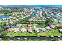 Stunning aerial view of a waterfront community with lush landscaping and canal access to open water at 175 Inlets Blvd # 175, Nokomis, FL 34275