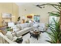 Bright living room with high ceilings, modern decor, comfortable seating, and access to dining area at 175 Inlets Blvd # 175, Nokomis, FL 34275