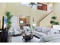 Inviting living room with vaulted ceiling, comfortable seating, and a staircase leading to the upper level at 175 Inlets Blvd # 175, Nokomis, FL 34275