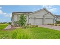 Well-maintained home with a two-car garage, brick driveway, and beautiful landscaping adding curb appeal at 17817 Pastureland Ave, Lakewood Ranch, FL 34211