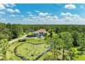 Beautiful home surrounded by lush greenery, featuring a picturesque pond at 20207 71St E Ave, Bradenton, FL 34211